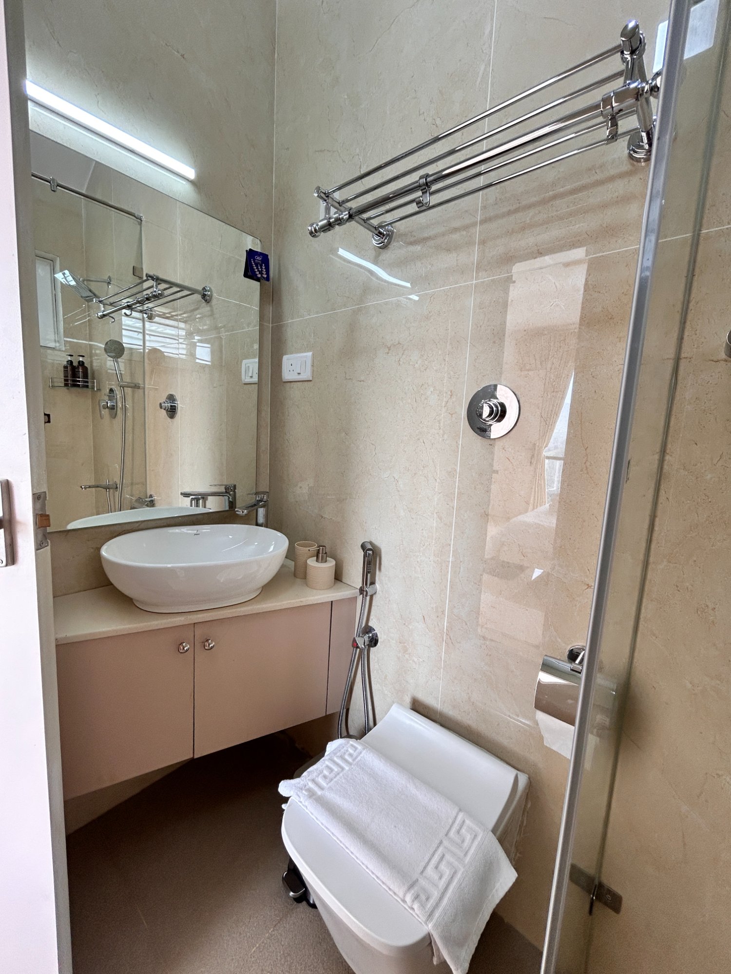Bathroom with bowl sink and pink vanity cabinet