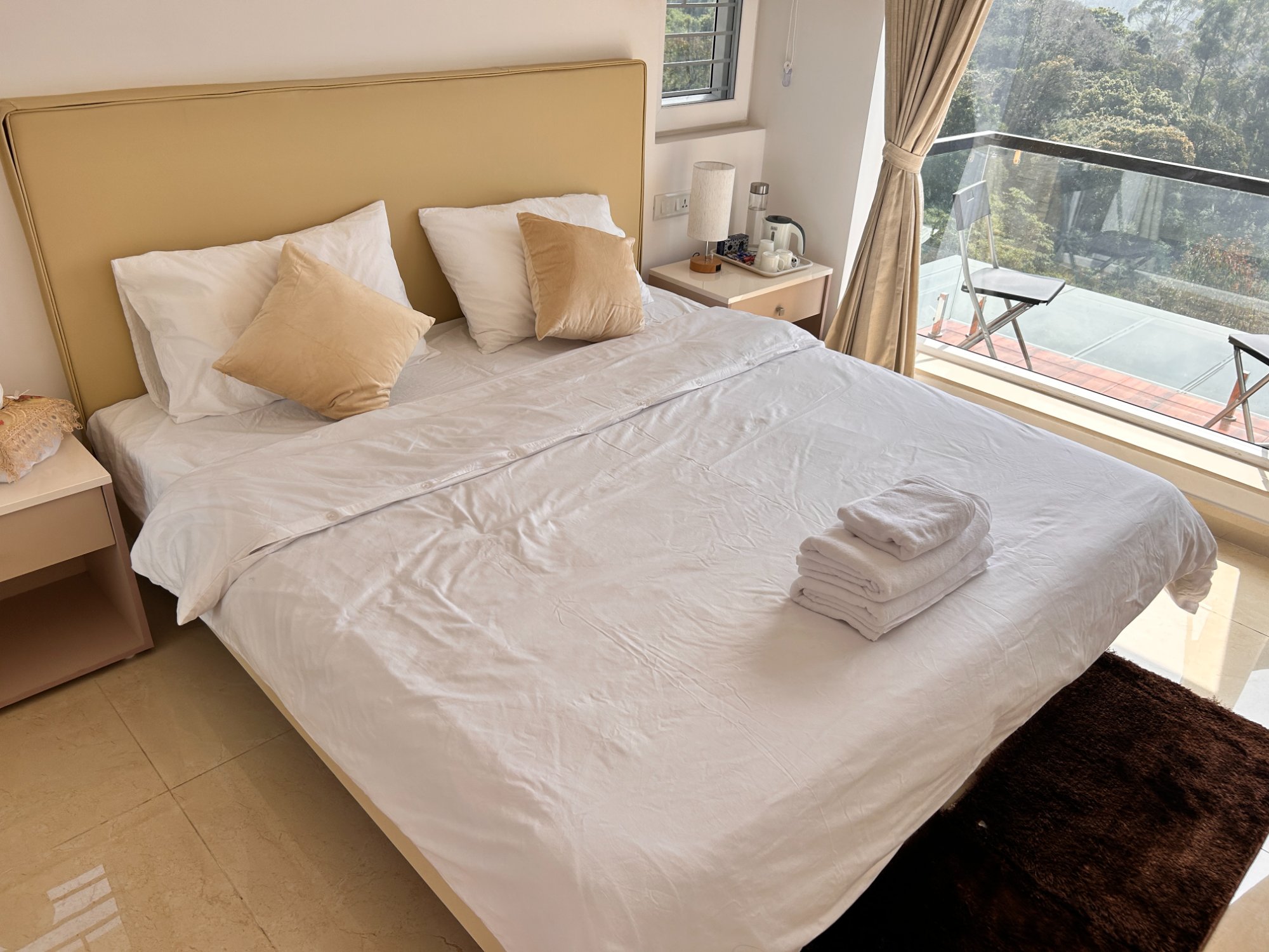 Bedroom with forest balcony view