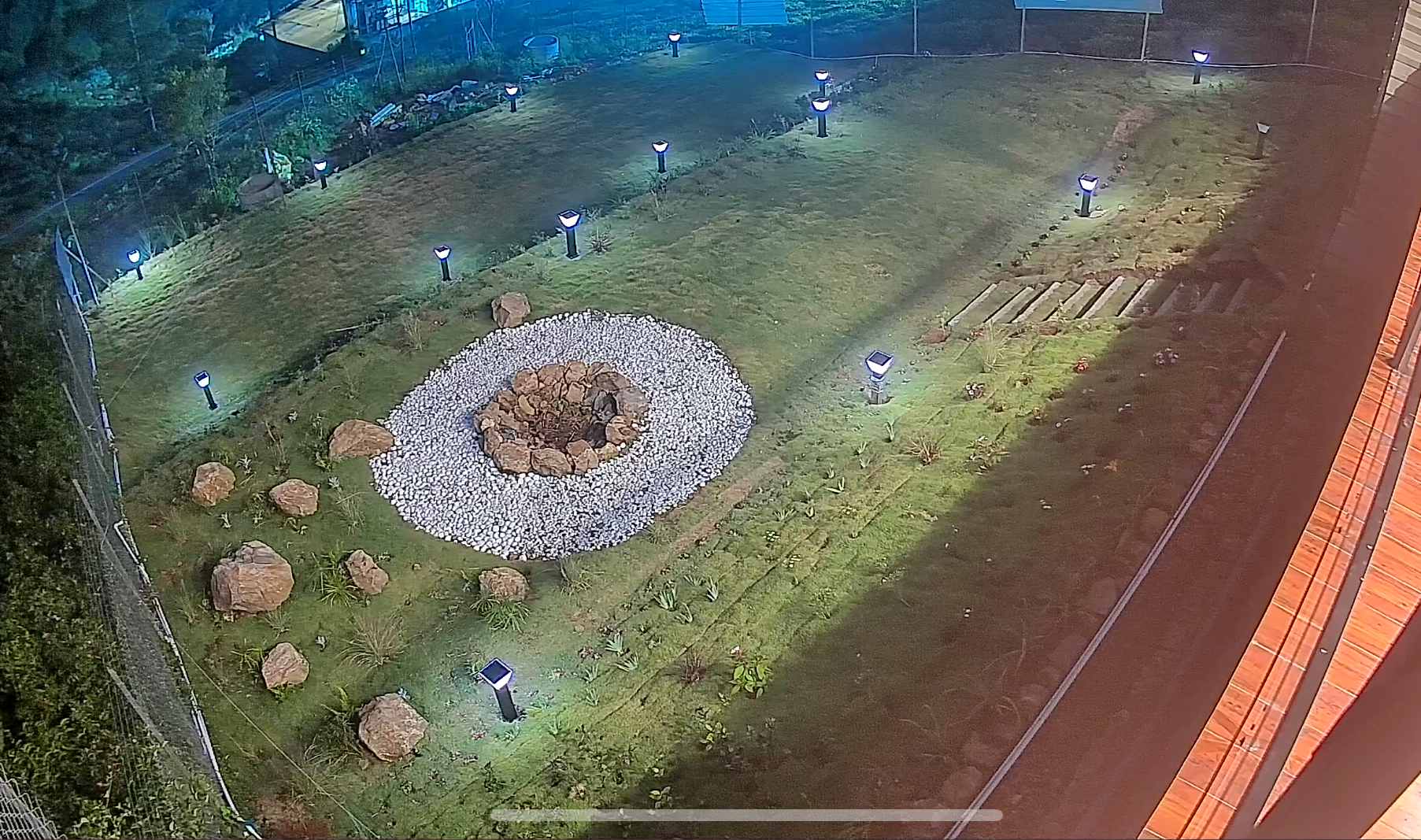 Garden and fire pit lit up at night
