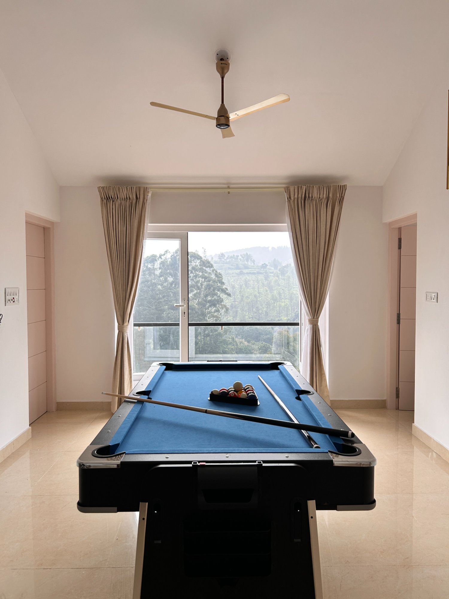 Billiards table with misty hill view