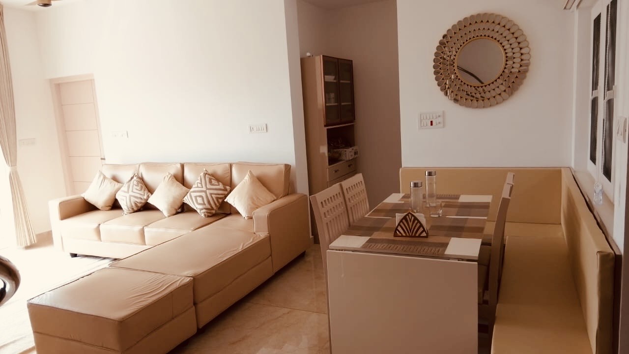 Living and dining area with sunburst mirror
